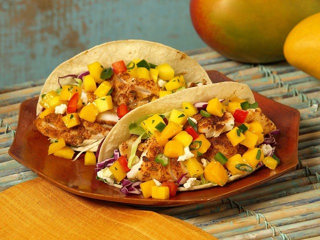 two plated tacos with chicken and mango salsa